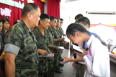 High ranking officials from the Marine Corps Savings Cooperative distribute scholarships to children of the Marine Corp.